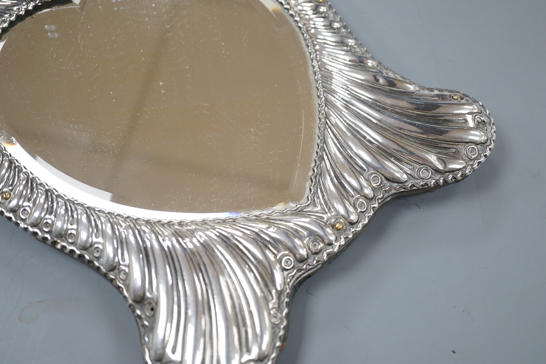 A late Victorian repousse silver mounted heart shape easel mirror, William Comyns, London, 1900, 26.5cm.